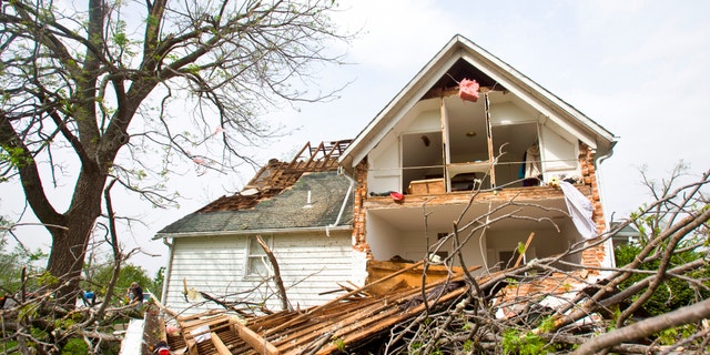 A house sits ripped-open from a tornado on Sunday, April 15, 2012 in Thurman, Iowa. Thurman appeared to be the hardest hit community in Iowa, but storms caused damage elsewhere in the state, as well as in Nebraska. There were more than 100 reports of tornadoes across the middle of the country through dawn Sunday, forecasters said. (AP Photo/The Journal-Star, Patrick Breen)