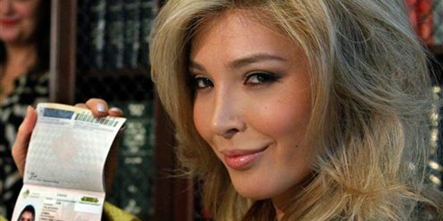 April 3: Jenna Talackova, who advanced to the finals of the Miss Canada competition, part of the Miss Universe contest, and was recently forced out of the competition, shows her passport that lists her gender as female, at a news conference in Los Angeles.