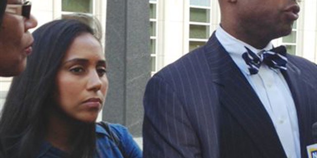 FILE- In this July 3, 2013 file photo, former Metropolitan Detention Center guard, Nancy Gonzalez, center, listens as her attorney, Anthony Rico, speaks to members of the media outside the federal courthouse in the Brooklyn borough of New York. Gonzalez gained notoriety by conceiving a baby behind bars with a cop killer. Although she claims to have had clandestine sexual encounters with at least eight co-workers and a second inmate while on duty at the Metropolitan Detention Center, it remains unclear if anyone else has been disciplined. (AP Photo/Tom Hays, File)
