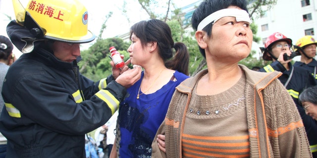 September 27: A rescue worker tends to passengers injured after a subway train accident in Shanghai.