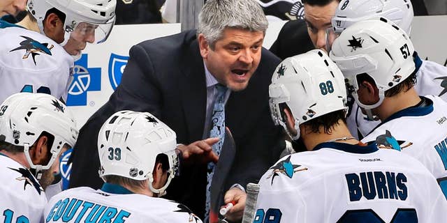 FILE - In this March 29, 2015, file photo, San Jose Sharks head coach Todd McLellan, center, talks to his team during a timeout in the third period of an NHL hockey game against the Pittsburgh Penguins in Pittsburgh. The Sharks announced Monday, April 20. 2015, that they had agreed to part ways with McLellan, the winningest coach in franchise history after the team missed the playoffs for the first time since 2003. (AP Photo/Gene J. Puskar, File)