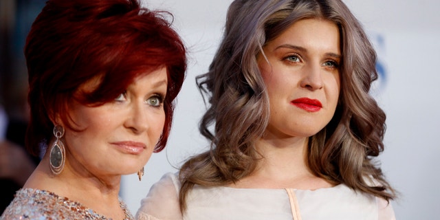 Television host Sharon Osbourne, left, and her daughter Kelly Osbourne pose as they arrive at the 2012 People's Choice Awards in Los Angeles January 11, 2012.