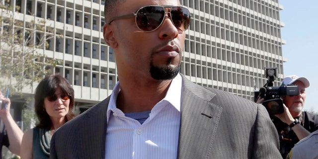 Feb. 14, 2014: Former NFL safety Darren Sharper leaves a courthouse in Los Angeles. An arrest warrant has been issued for Sharper and another man, accusing them of raping two women in New Orleans last year. Sharper also is under investigation in sexual assault cases in Florida, Nevada and Arizona and has pleaded not guilty to rape charges in Los Angeles. (AP/Nick Ut )