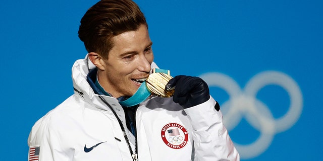 Men's halfpipe gold medalist Shaun White, of the United States, bites his medal during the medals ceremony at the 2018 Winter Olympics in Pyeongchang, South Korea, Wednesday, Feb. 14, 2018.