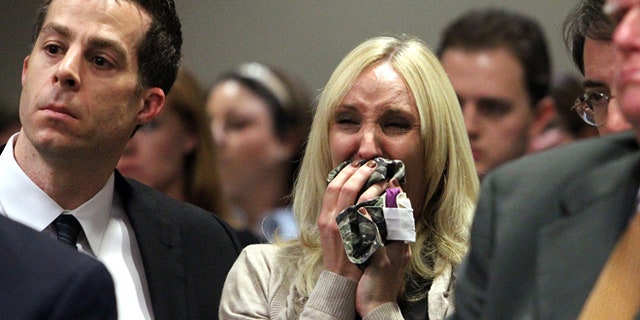 Feb. 5: Nicole Oulson, whose husband was shot inside a movie theater, reacts at the alleged shooter's bond hearing.