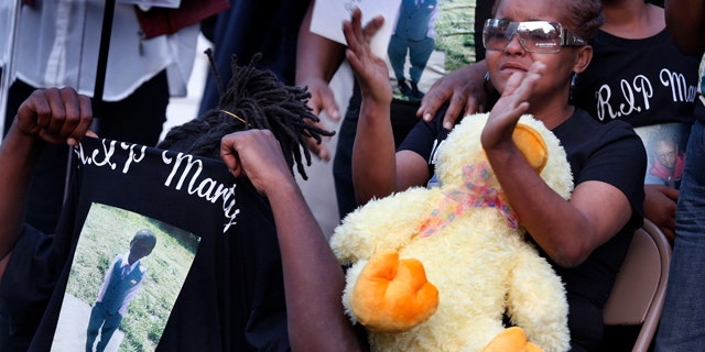 May 3, 2014: Sharain Spruill, mother of Martin Cobb, is surrounded by family during his prayer vigil. A 16-year-old boy was charged Saturday in the assault of a young girl and the killing of her 8-year-old brother, Martin, who was apparently slain when he tried to protect her, authorities and relatives said. (AP Photo/Richmond Times-Dispatch, Dean Hoffmeyer)