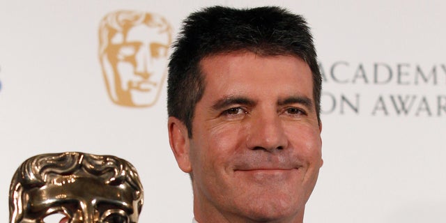June 6: Television mogul Simon Cowell poses after receiving the British Academy Television Awards Special Award at the Palladium Theatre in London.