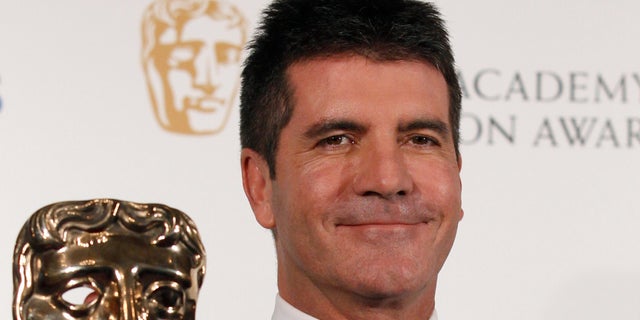 June 6: Television mogul Simon Cowell poses after receiving the British Academy Television Awards Special Award at the Palladium Theatre in London.