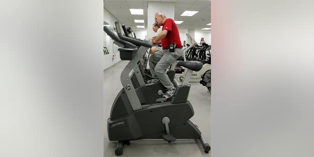 A cardiac patient rides an exercise bike at the Cleveland Clinic in this file photo.