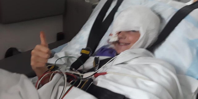 Skylar, 10, was standing behind and off to the side of her father while he mowed the lawn.