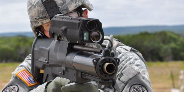 File photo - a soldier aims an XM25 Counter Defilade Target Engagement weapon system at Aberdeen Test Center, Md.