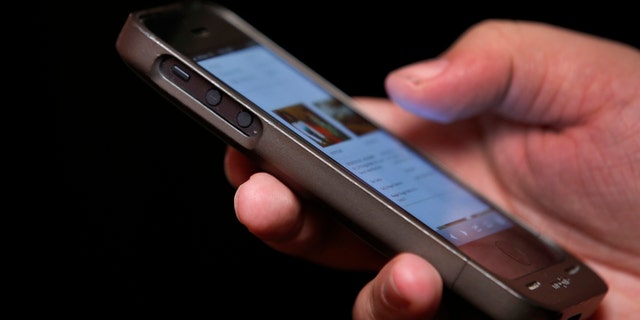 In this photo taken on November 6, 2013, a man uses a smartphone in New York City.