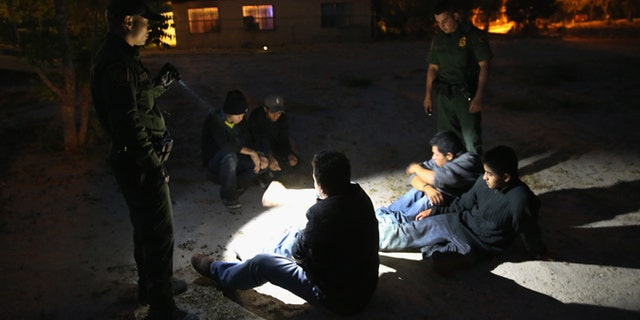 MISSION, TX - APRIL 11: U.S. Border Patrol agents detain undocumented immigrants who had crossed from Mexico into the United States on April 11, 2013 in Mission, Texas. In the last month the Border Patrol's Rio Grande Valley sector has seen a spike in the number of immigrants crossing the river from Mexico into Texas. With more apprehensions, they have struggled to deal with overcrowding while undocumented immigrants are processed for deportation. According to the Border Patrol, undocumented immigrant crossings have increased more than 50 percent in Texas' Rio Grande Valley sector in the last year. Border Patrol agents say they have also seen an additional surge in immigrant traffic since immigration reform negotiations began this year in Washington D.C. Proposed refoms could provide a path to citizenship for many of the estimated 11 million undocumented workers living in the United States. (Photo by John Moore/Getty Images)