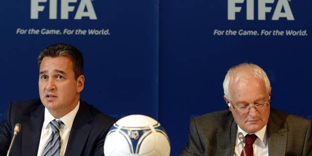 FILE - In this Friday, July 27, 2012 file photo, Chairmen of the two chambers of the new FIFA Ethics Committee Michael Garcia, left, from the US and Joachim Eckert, right, from Germany attend a press conference, at the Home of FIFA in Zurich, Switzerland. FIFA ethics judge Joachim Eckert is unlikely to reach final decisions in the 2018 and 2022 World Cup bidding corruption probe until early next year. The German judge also suggested on Friday, Sept. 19, 2014, it was not his job to remove Russia or Qatar as hosts or order a re-vote based on FIFA prosecutor Michael Garcia's investigation. (AP Photo/Keystone, Walter Bieri, File)