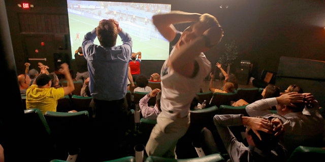 FILE - In this July 1, 2014, file photo, fans react during the United States' loss to Belgium in a 2014 World Cup soccer match at the FilmBar movie theater in Phoenix, Arizona. Telemundo announced Thursday Feb. 12, 2015, that it has extended its contract with FIFA for the United States TV rights all the way to the 2026 Soccer World Cup. (AP Photo/Ross D. Franklin, File)