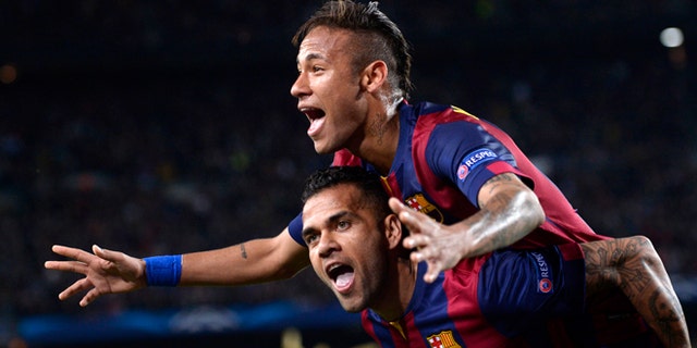 Barcelona's Neymar celebrates on the shoulders of teammate Dani Alves, after scoring his second goal during the Champions League quarterfinal second leg soccer match between FC Barcelona and Paris Saint Germain at the Camp Nou Stadium in Barcelona, Spain, Tuesday, April 21, 2015. (AP Photo/Manu Fernandez)