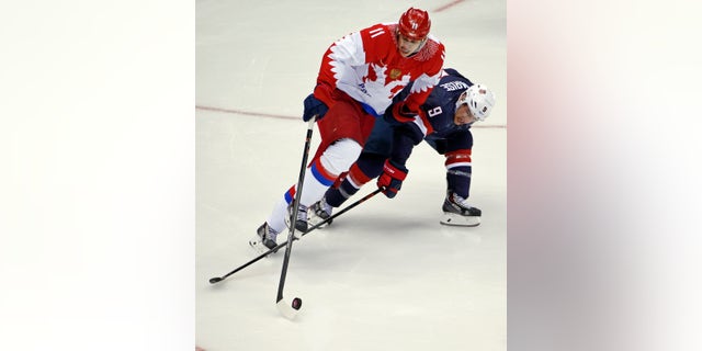 Feb. 15, 2014: Russia forward Yevgeni Malkin and USA forward Zach Parise battle for the puck in the third period of a men's ice hockey game at the 2014 Winter Olympics in Sochi, Russia.