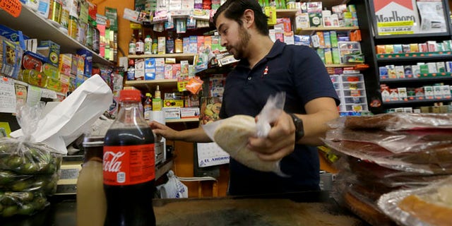 Alex Del Rio works at his family's market El Ahorro in San Francisco, Wednesday, Sept. 21, 2016.