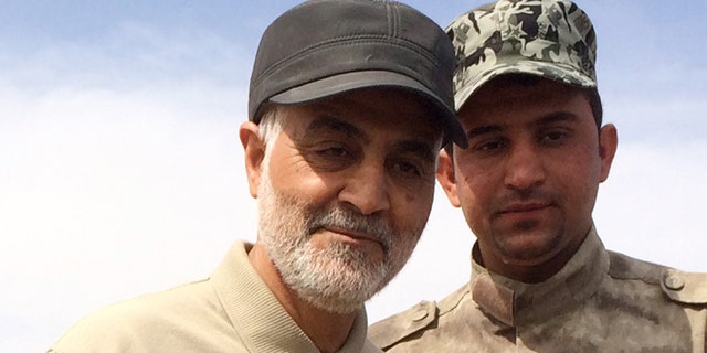 March 8, 2015: Gen. Qassem Soleimani, left, stands at the frontline during offensive operations against Islamic State militants in the town of Tal Ksaiba, Iraq.