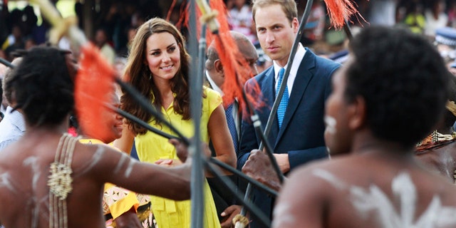 Sept. 17, 2012: Britain's William and his wife Kate, top center, the Duke and Duchess of Cambridge, watch a traditional dance at the Cultural Village in Honiara, Solomon Islands.