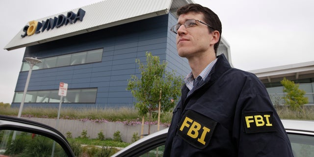 Sept. 8, 2011: FBI agents stand guard outside of Solyndra headquarters in Fremont, Calif. 