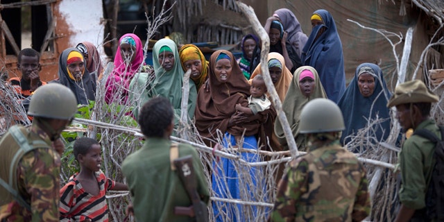 Dec. 13: Female villagers speak to soldiers from both the Kenyan army and a Kenyan-allied Somali militia, in Ras Kamboni, southern Somalia.