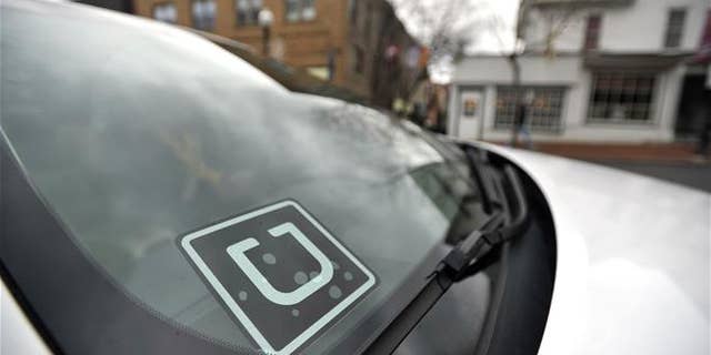 In this photo taken Feb. 25, 2016, an Uber decal is displayed in the their window of the car owned by Steve Linnes, a music teacher in State College, Pa., who is also a part-time Uber driver.
