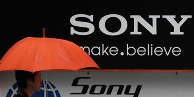 A man walks past a Sony logo in front of an electronic shop in Tokyo May 3, 2011.