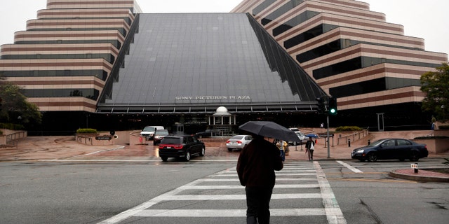 Pedestrians cross a street in front of the Sony Pictures Entertainment headquarters in Culver City, Calif. on Dec. 2, 2014.