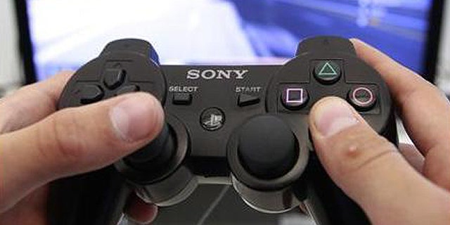 A person plays a video game at a Sony Playstation in the Sony's flagship store in Berlin, April 27, 2011.
