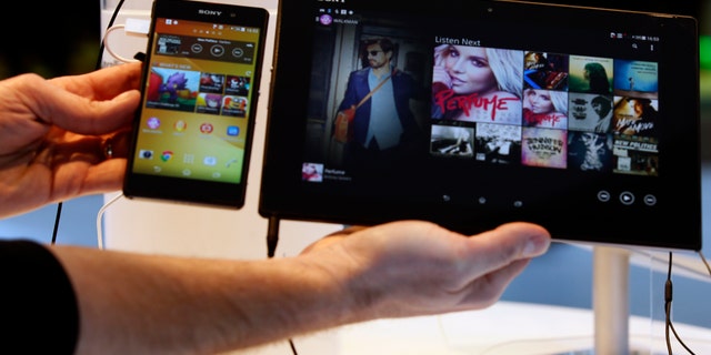 REFILE - CORRECTING GRAMMAR A Sony Xperia Z2 smartphone (L) and a Sony Xperia Z2 tablet are displayed at the company's stand during the Mobile World Congress in Barcelona February 24, 2014. The congress is the wireless industry's largest annual conference and runs February 24-27, 2014. REUTERS/Gustau Nacarino (SPAIN - Tags: BUSINESS TELECOMS) - RTX19EQR