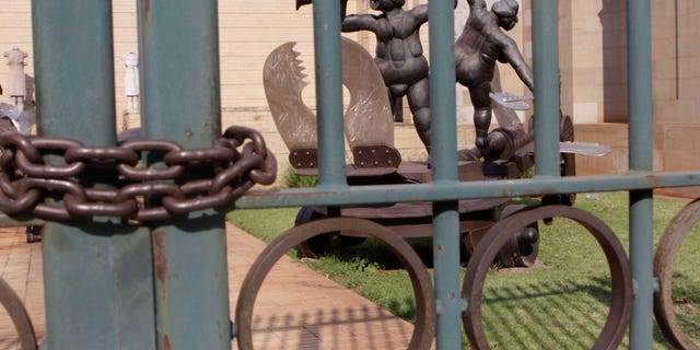 Oct. 11, 2011: A metal sculpture titled: "Tightroping" by sculptor David Brown is seen locked behind bars at the Johannesburg Art Gallery.