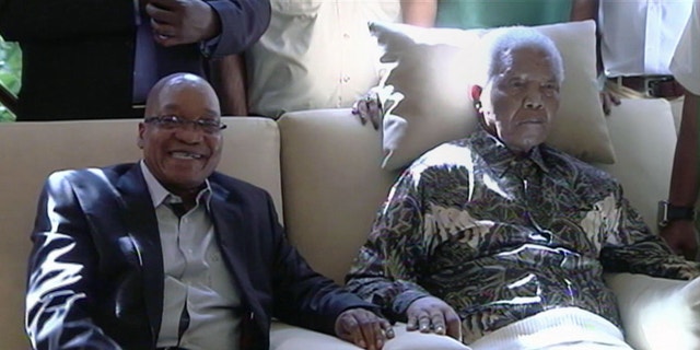 April 29, 2013 - In this image taken from video, South African President Jacob Zuma, left, sits with the ailing anti-apartheid icon Nelson Mandela.