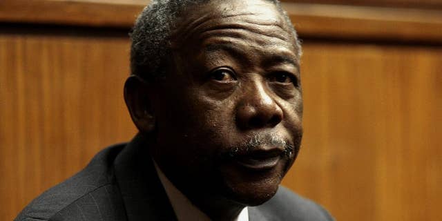 FILE - In this Tuesday, Aug. 3, 2010 file photo, South African former police commissioner Jackie Selebi attends his sentencing on corruption charges at the High Court in Johannesburg, South Africa. The family of South Africa’s former national police chief, Jackie Selebi, who was disgraced after he was found guilty of corruption, said on Friday, Jan. 23, 2015 that he has died following a long illness. (AP Photo-File)