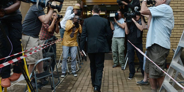 October 14, 2014: Oscar Pistorius enters court to face day two of sentencing processes for the shooting death of his girlfriend Reeva Steenkamp. Pistorius was found guilty last month on a culpable homicide charge. (AP Photo)