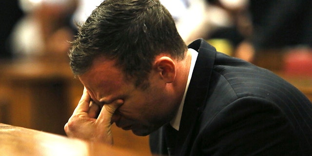FILE - In this Friday, Sept. 12, 2015 file photo, Oscar Pistorius puts his hand on his face in court in Pretoria, South Africa, as judgement is passed in the shooting death of his girlfriend, Reeva Steenkamp. (AP Photo/Alon Skuy, Pool, File)