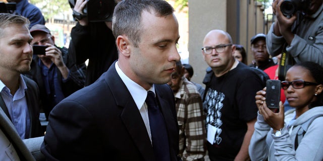 April 15, 2014: Oscar Pistorius arrives at the high court in Pretoria, South Africa. (AP Photo/Themba Hadebe)