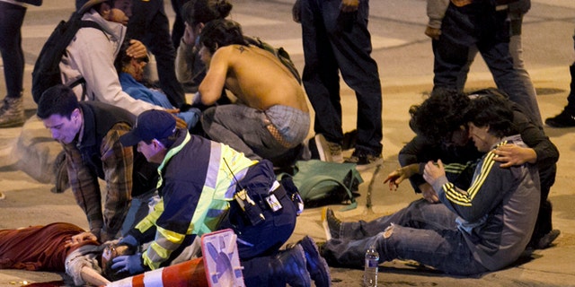 People are treated after being struck by a vehicle on Red River Street in downtown Austin, Texas, on Wednesday March 12, 2014. Police say two people were confirmed dead at the scene after a car drove through temporary barricades set up for the South By Southwest festival and struck a crowd of pedestrians. The condition of the victims shown is unknown. (AP Photo/Austin American-Statesman, Jay Janner) AUSTIN CHRONICLE OUT, COMMUNITY IMPACT OUT, MAGS OUT; NO SALES; INTERNET AND TV MUST CREDIT PHOTOGRAPHER AND STATESMAN.COM