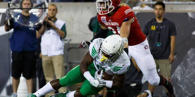 Oregon running back Byron Marshall makes a touchdown catch in the end zone during the second quarter of an NCAA college football game against South Dakota in Eugene, Ore., Saturday, Aug. 30, 2014. At right is South Dakota's Jacob Warner. (AP Photo/Ryan Kang)