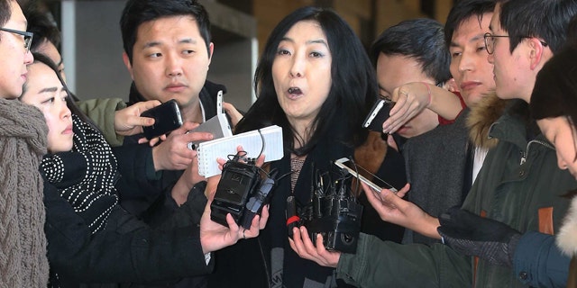 Jan. 7, 2015: California-resident Shin Eun-mi, center, talks to reporters at Seoul District Prosecutors' Office. South Korean officials say they were considering whether to deport the Korean-American woman accused of praising rival North Korea during a recent lecture. (AP Photo/Yonhap, Park Ji-ho)