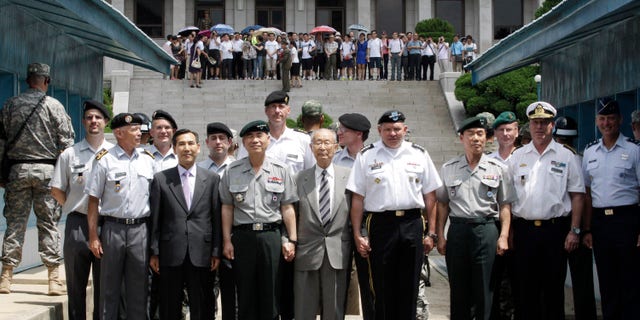 U.S. Gen. James D. Thurman, the commander of U.S. Forces Korea, fourth from right, poses with Neutral Nations Supervisory Commission, United Nations Forces and South Korean officers after a ceremony marking the 59th anniversary of the signing of the armistice agreement that ended the Korean War on July 27, 1953, at the border villages of Panmunjom, South Korea, Friday, July 27, 2012. (AP Photo/Ahn Young-joon. Pool)