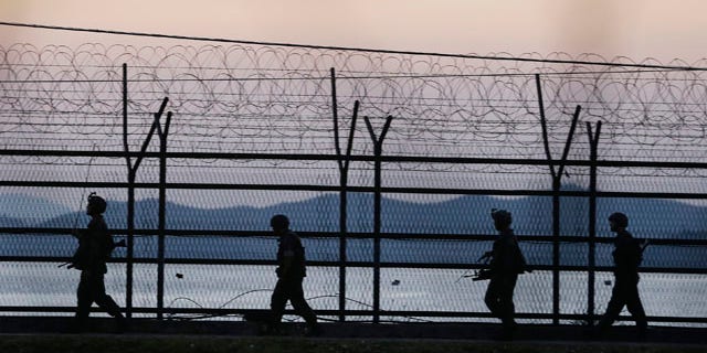 October 7, 2014: South Korean army soldiers patrol through the wire fences near the demilitarized zone between the two Koreas in Paju, South Korea. (AP Photo/Ahn Young-joon)