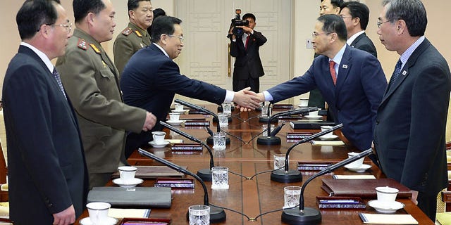 February 12, 2014: In this photo released by the South Korean Unification Ministry, South Korean chief delegate Kim Kyou-hyun, second from right, shakes hands with his North Korean counterpart Won Tong Yon, third from left, during their meeting at the border village of Panumjom, South Korea. (AP Photo/South Korean Unification Ministry)