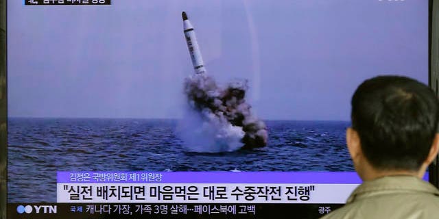 May 9, 2015: A South Korean man watches a TV news program showing an image published in North Korea's Rodong Sinmun newspaper of North Korea's ballistic missile believed to have been launched from underwater, at Seoul Railway station.(AP Photo/Ahn Young-oon)