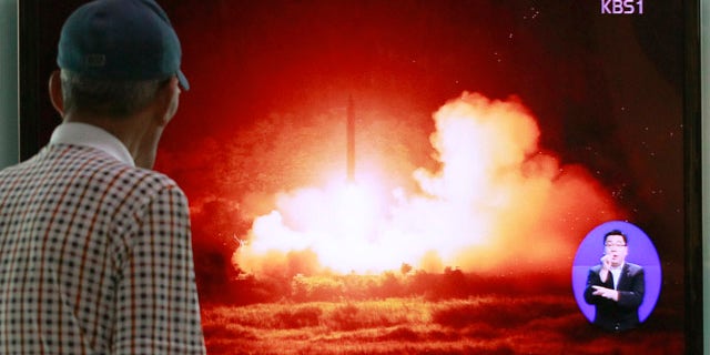 July 13, 2014: A man watches a TV news program showing a file picture of a missile launch conducted by North Korea, at Seoul Railway Station in Seoul, South Korea. (AP Photo/Ahn Young-joon)