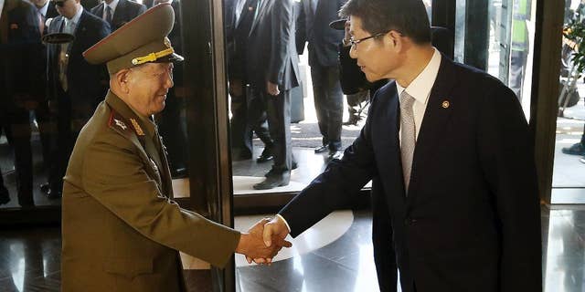 Oct. 4, 2014: Hwang Pyong So, left, vice chairman of North Korea’s National Defense Commission, shakes hands with South Korean Unification Minister Ryoo Kihl-jae upon his arrival at a hotel in Incheon, South Korea.