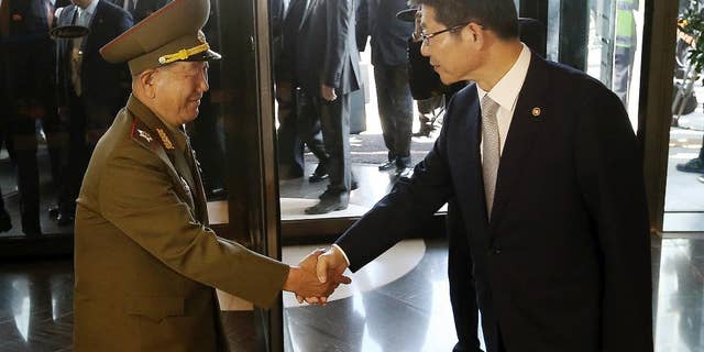 Oct. 4, 2014: Hwang Pyong So, left, vice chairman of North Korea’s National Defense Commission, shakes hands with South Korean Unification Minister Ryoo Kihl-jae upon his arrival at a hotel in Incheon, South Korea.