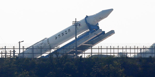 Oct. 26, 2012: The Korea Space Launch Vehicle-1 (KSLV-1) is lowered from a launch pad for checking at the Naro Space Center in Goheung, South Korea. South Korea has been forced to postpone its third attempt to launch a satellite into space from its own soil because of a last-minute technical glitch.