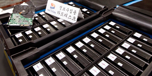 South Korean officials from the National Police Agency's Cyber Terror Response Center show some of the hard disks taken from the office of Google Korea at the headquarter of the National Police Agency in Seoul, South Korea. Google has been accused of collecting e-mails and other personal information from unsecured wireless networks while it took photos of neighborhoods in South Korea for its "Street View" mapping service.