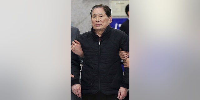 April 17, 2014: Kim Han-sik, president of Chonghaejin, is escorted by helpers to hold a press conference at Incheon Port International Passenger Terminal in Incheon, South Korea. South Korean prosecutors on Thursday detained Kim, the head of the company that owns the ferry that sank last month, over an allegation of cargo overloading.(AP Photo/Yonhap) KOREA OUT
